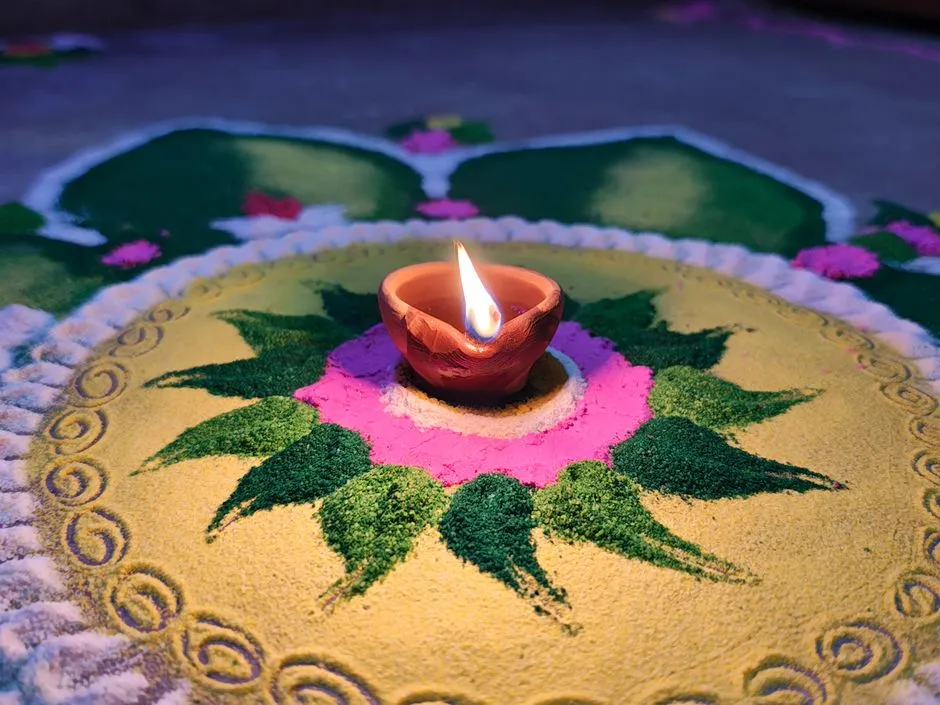 A colorful rangoli design with a lit clay diya lamp, illustrative of Diwali decoration traditions