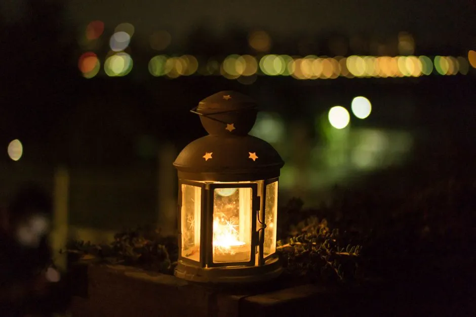A lit lantern glowing at night, illustrative of Ramadan and Eid lantern traditions